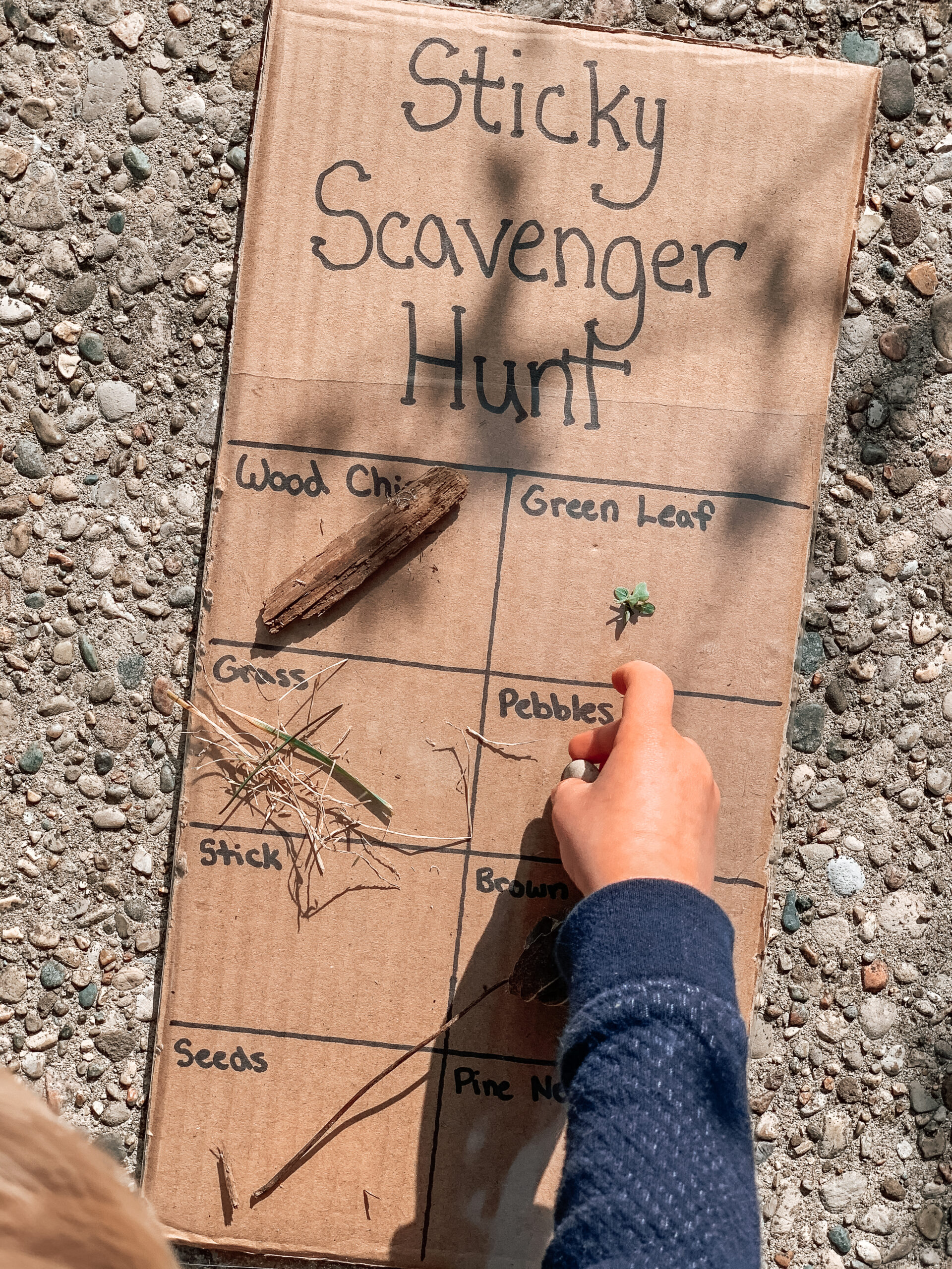 Kid playing with sticky nature scavenger hunt