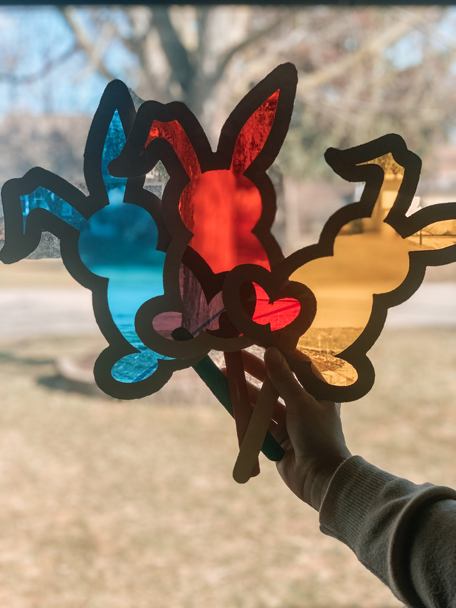Kids Easter bunny suncatcher craft activity for learning primary and secondary color combinations. Made of repurposed cardboard and cellophane sheets