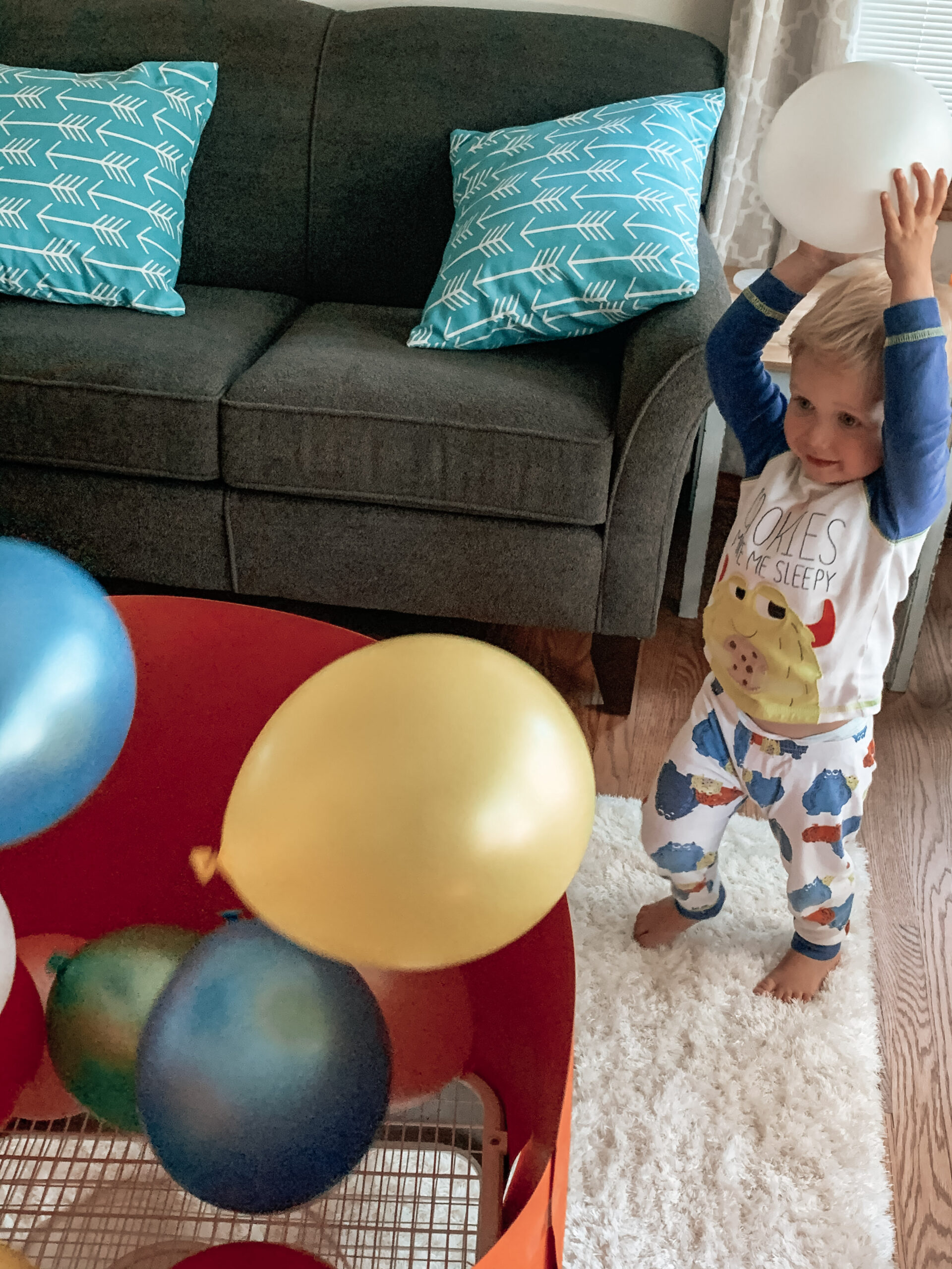 Kid throwing a balloon back to the fan playing with a completed poster board craft and balloon activity