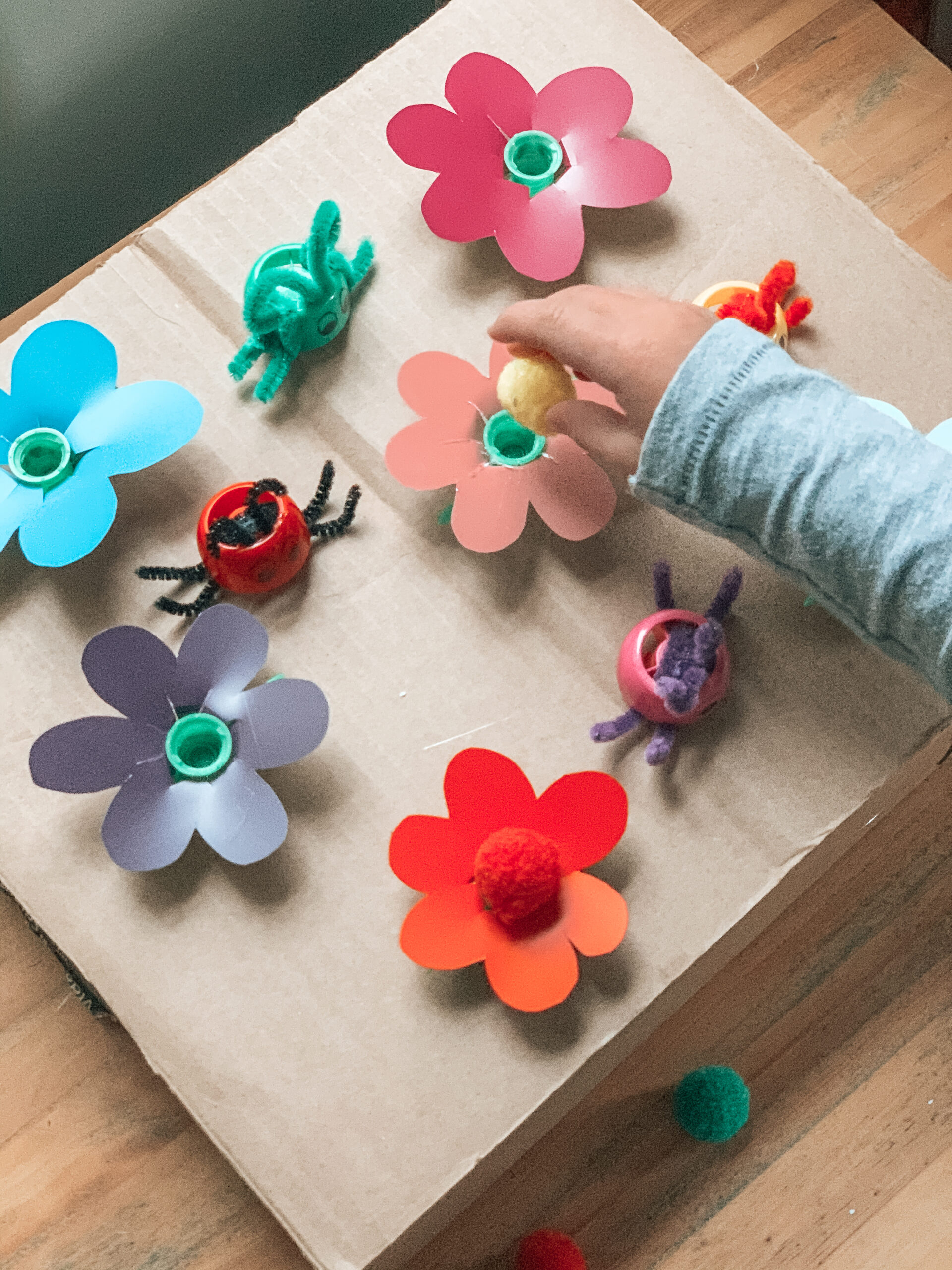 Kid playing with pouch cap garden fine motor activity